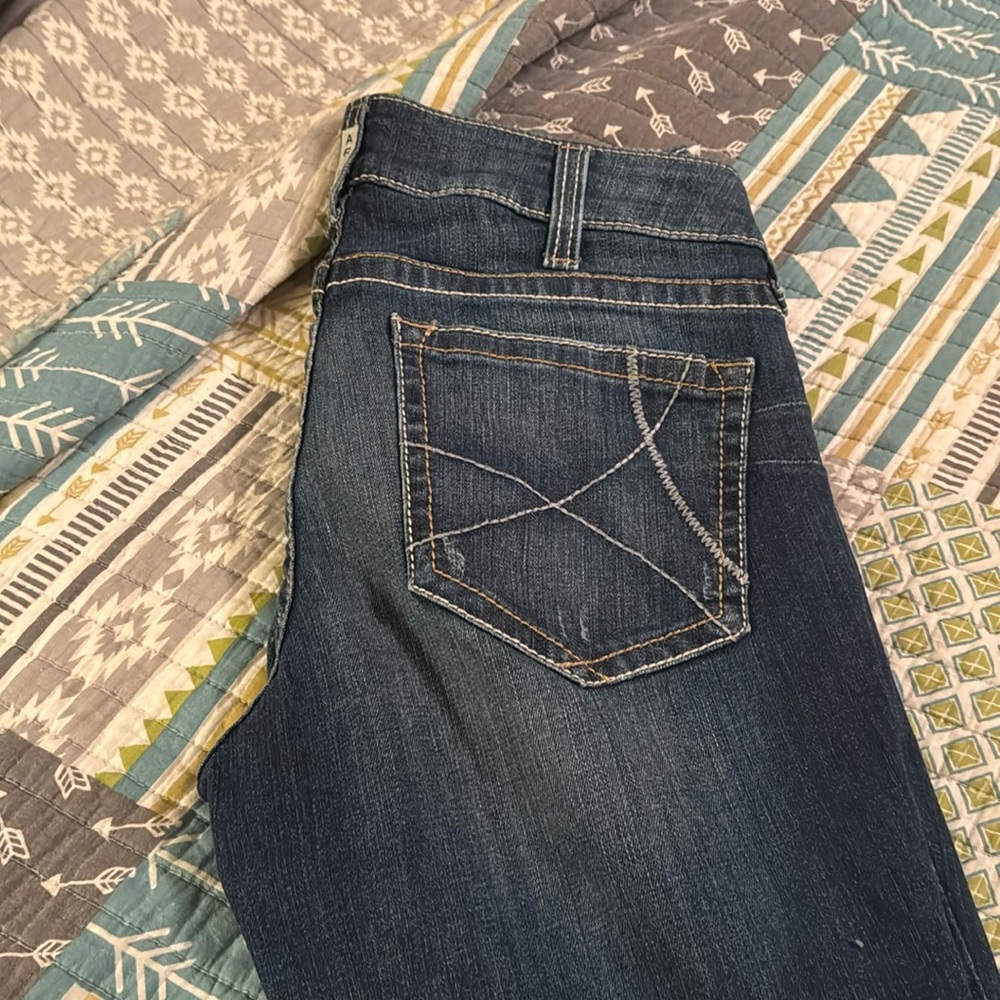 Ariat jeans with frayed bottoms